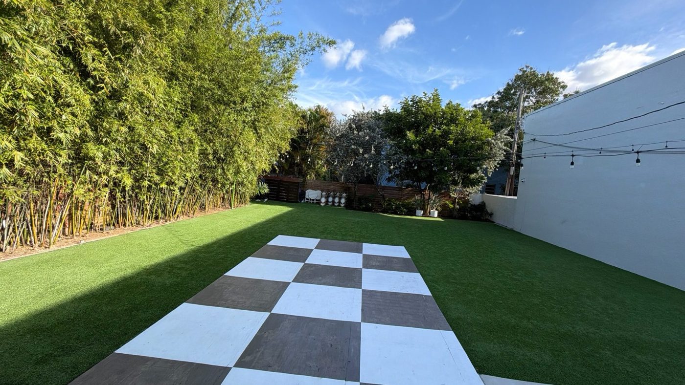 Checkerboard dance floor on the outdoor lawn in daylight